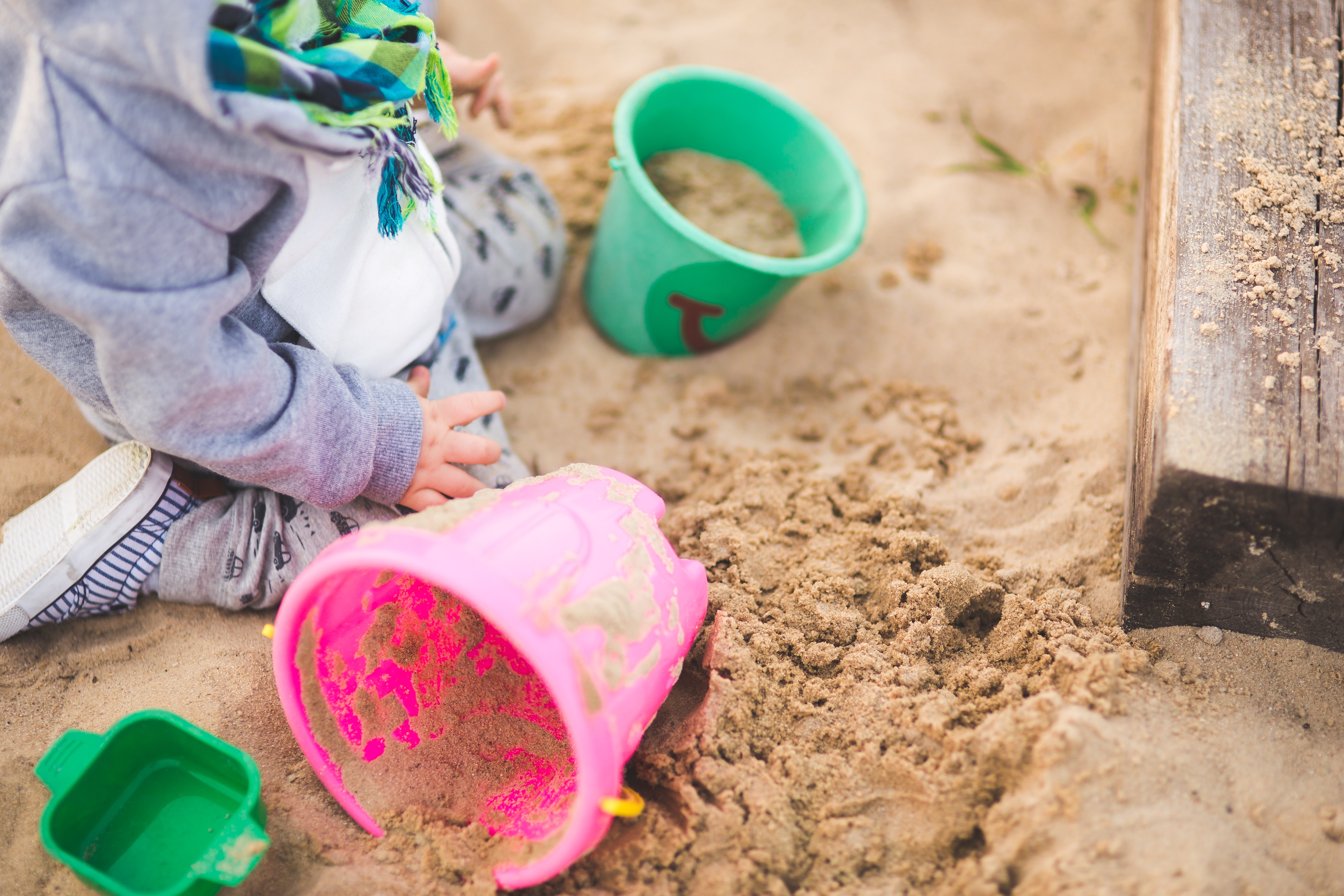 Kid playing with sand on the playground